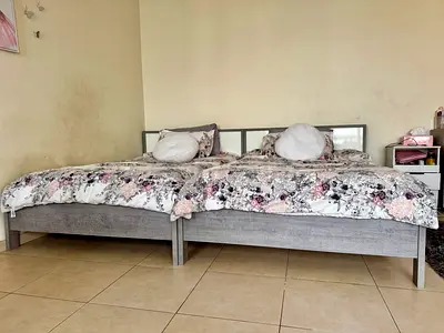 Two single wooden beds (can be used as double) with mattresses