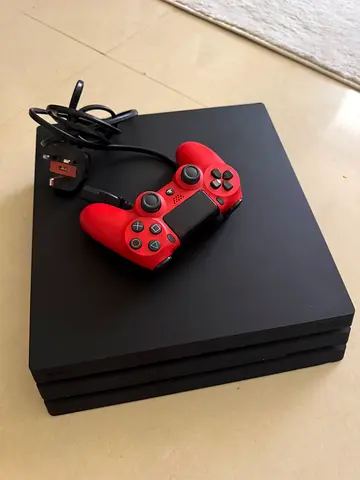 PlayStation 4 Pro with red DualShock 4 controller and 2 cd games- good condition