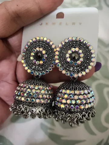 Pair of silver-tone jhumka earrings with iridescent stones