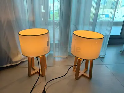 Pair of wooden tripod table lamps with white drum shades