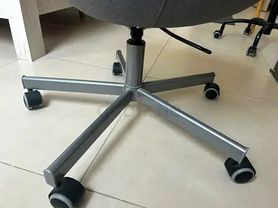 Grey ergonomic office chair with swivel base and casters - good condition