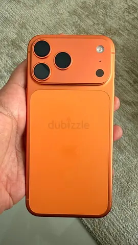 iPhone (orange/peach) with protective case - good working condition