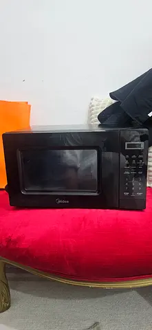 Used Midea countertop microwave - black