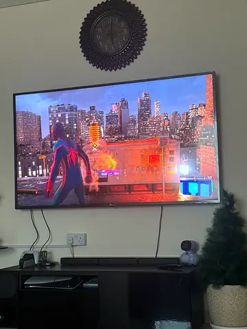 70-inch LG LED TV mounted with remote and cables included