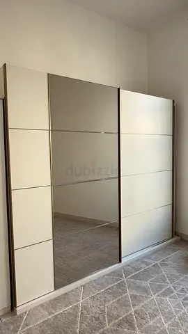 Modern sliding wardrobe with mirrored door - beige/cream
