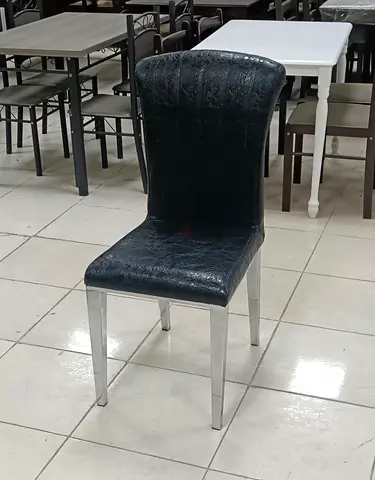 Black faux-leather dining chair with silver legs