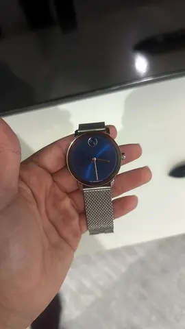 Movado-style minimalist men's watch with blue dial and mesh band