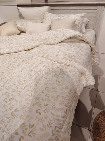 Beige king size bed frame without mattress
