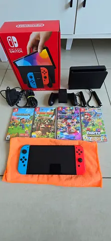 Nintendo Switch OLED console 64GB with all accesories plus 4 physical games in very good condition