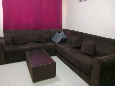 L-shaped brown fabric corner sofa with ottoman - good condition