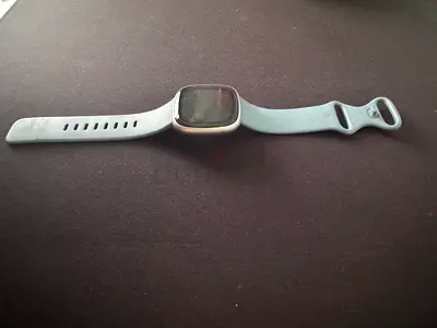 Used Fitbit Versa 4 square-screen fitness smartwatch with silicone band