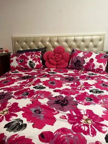 Queen bed with tufted faux leather headboard and floral bedding (ready to use)