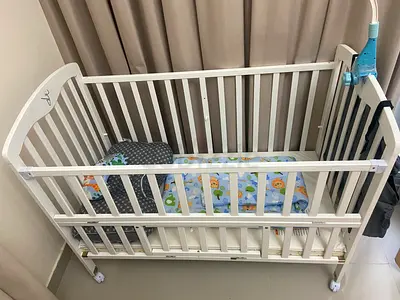 White Wooden Baby Crib with Wheels and Adjustable Side - Good Condition