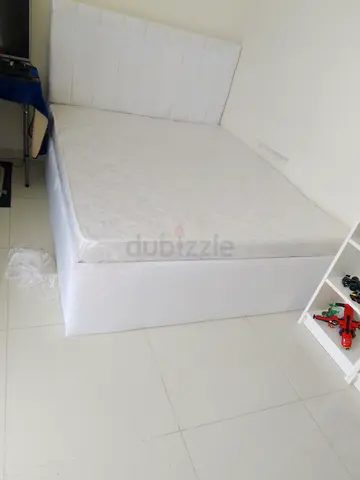 White double bed with mattress and upholstered headboard -