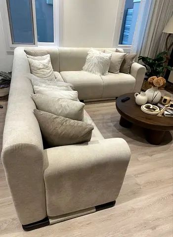 L-shaped 290X220 beige/cream fabric custom made sofa in good condition