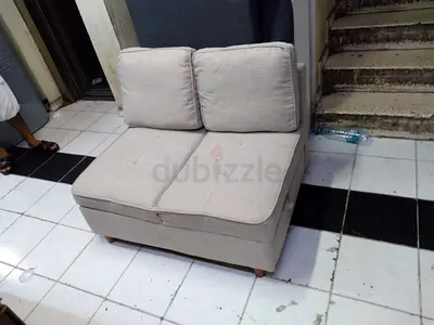 Two-seater beige fabric loveseat / small sofa - good condition