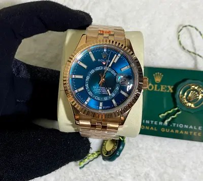 Rolex Sky-Dweller in 18k Everose gold with a striking blue-green dial and a Jubilee bracelet,