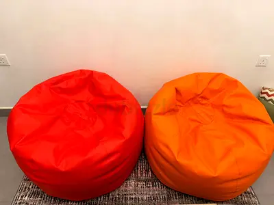 Pair of Round Vinyl Bean Bag Chairs - Red and Orange - Coffee Table