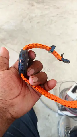 Used smartwatch with orange sport band (needs setup)