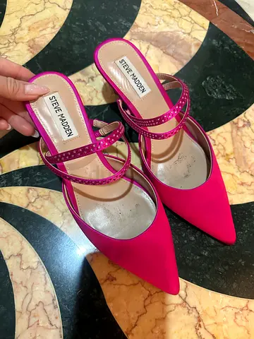 Pink high-heeled shoes with signs of wear