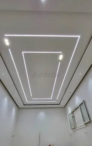 Modern recessed LED strip ceiling lights installation.