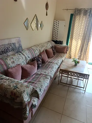 Large upholstered sofa with cushions and coffee table - good condition