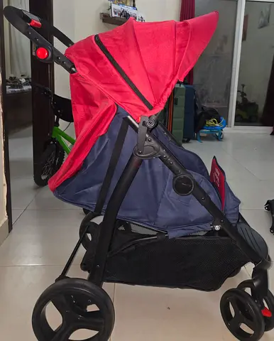 Lightweight red and navy standard baby stroller - good condition it has a food tray with cup holder