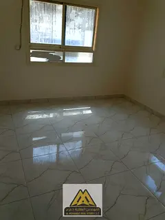 1BR in Al Rashidiya 3 behind Grand Mall, open-view balcony, split AC, AED 25,007, 4 or 6 cheques.