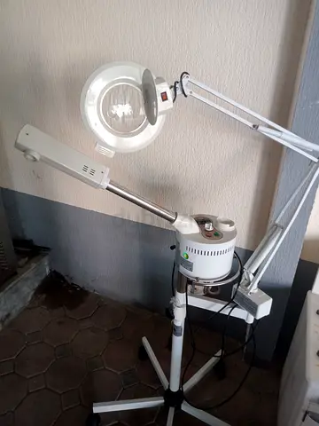 Professional facial steamer with magnifying lamp on rolling stand