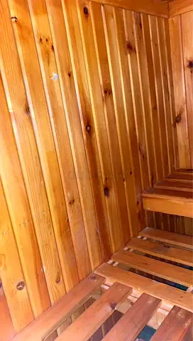 Used Wooden Home Sauna Cabin Interior — Benches & Pine Paneling