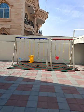 Outdoor metal swing set with 4 seats and safety mat - good condition