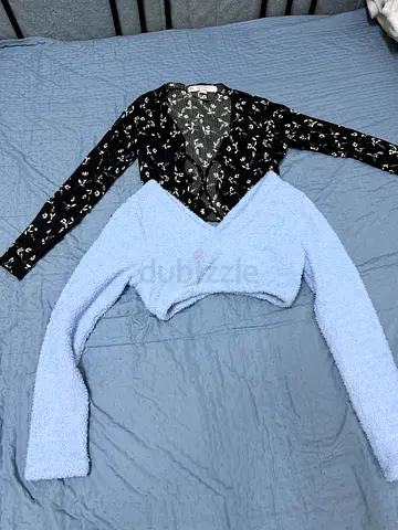 Two women's long-sleeve tops - black floral button-up and light blue fuzzy cropped sweater