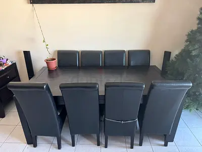 Solid dark wood dining table with 8 upholstered chairs - good condition