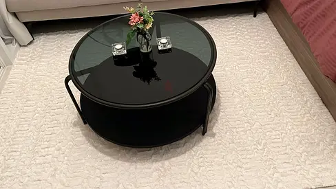 Round black glass coffee table with lower shelf - good condition