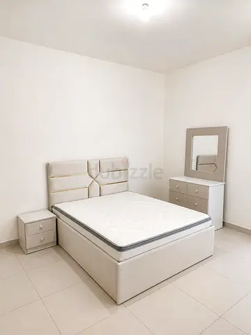 New Neutral beige upholstered bed with mattress, dresser and nightstand