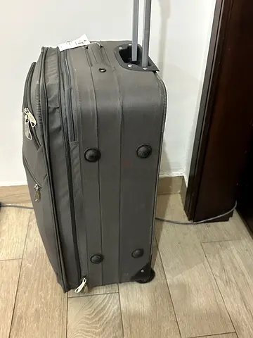 Grey soft-shell carry-on roller luggage with telescopic handle