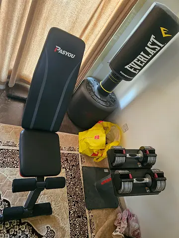 Adjustable dumbbells , bench , punching bag and resistance bands , home gym