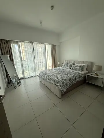 Modern upholstered double bed with mattress and bedside tables