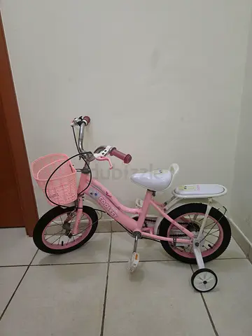 Pink kids bicycle with training wheels and basket - good condition
