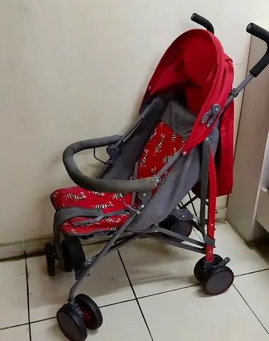 Red lightweight umbrella stroller in good used condition