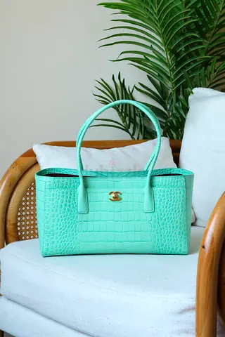 Mint green crocodile-effect structured handbag with gold clasp