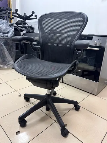 Herman Miller Ergonomic mesh office chair with adjustable armrests and headrest