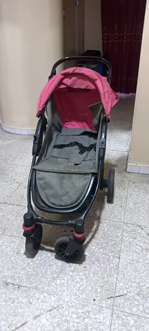 Used single baby stroller with pink canopy for 25AED