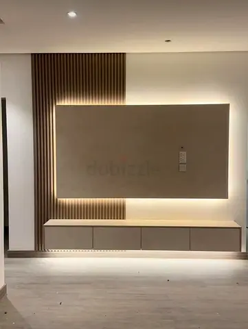 Modern wall-mounted TV unit with LED backlight and storage cabinet