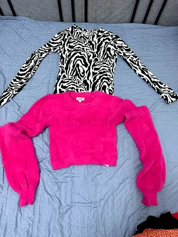 Two women's tops — zebra print long-sleeve and pink fuzzy sweater, size M
