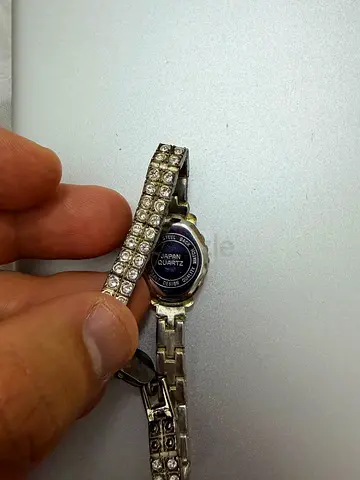 Ladies silver quartz watch with crystal-studded bracelet