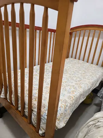 Solid wood baby crib in good condition with mattress