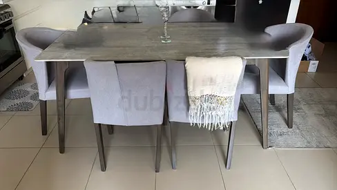 Modern grey dining table with 6 upholstered chairs