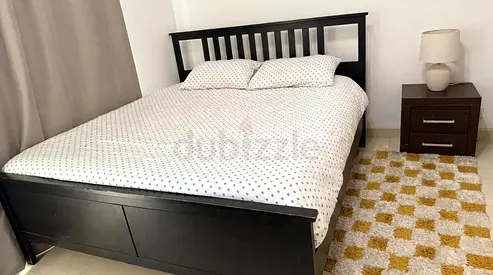 Ikea brand Solid dark wood double bed frame with mattress and side table included