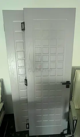 Pair of interior wooden doors with square panel design – good condition